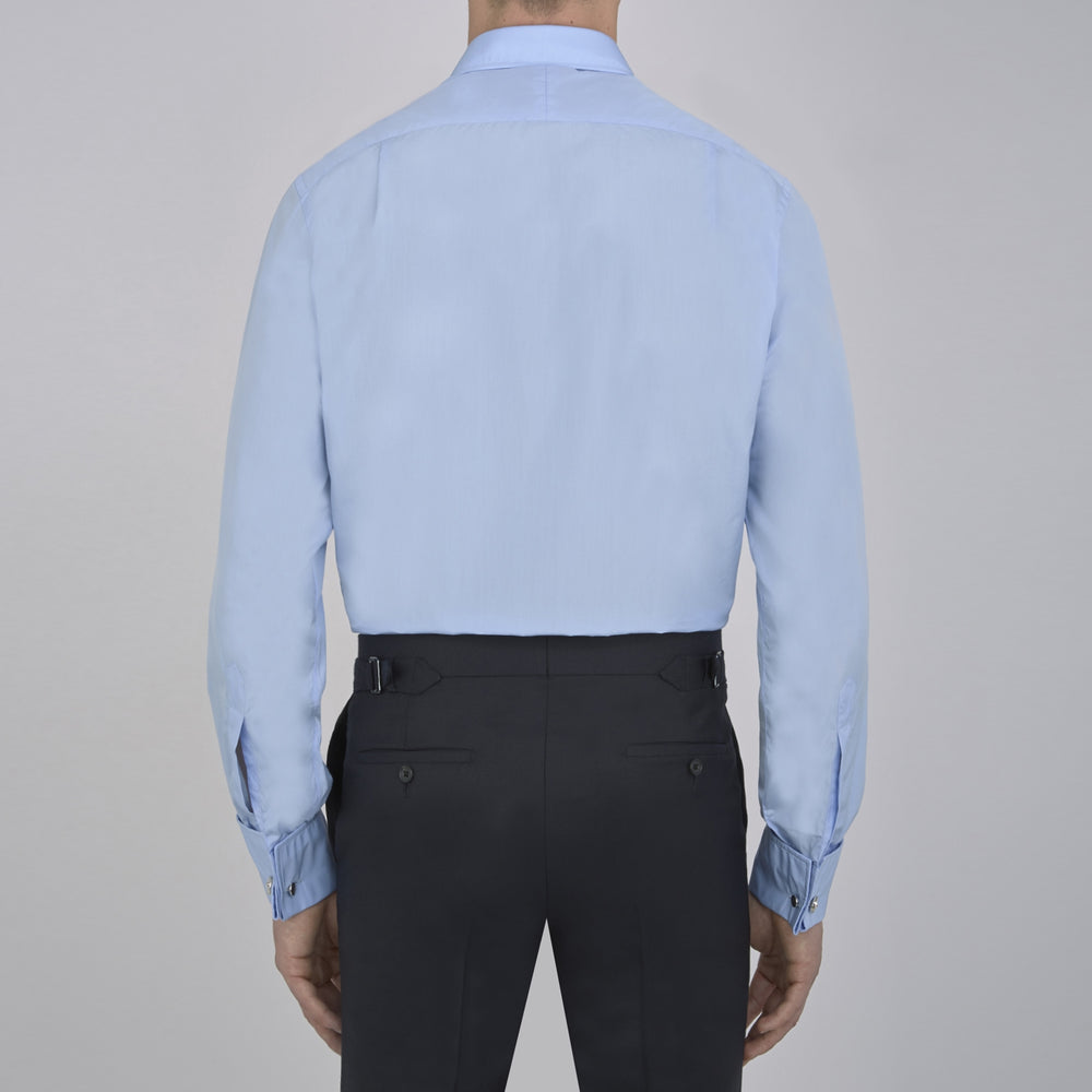 The Turnbull & Asser Two-Fold 200 Blue Cotton Shirt features a T&A collar, double cuffs, white buttons, and a visible label inside the collar, displayed neatly folded on a plain white background for superior breathability.