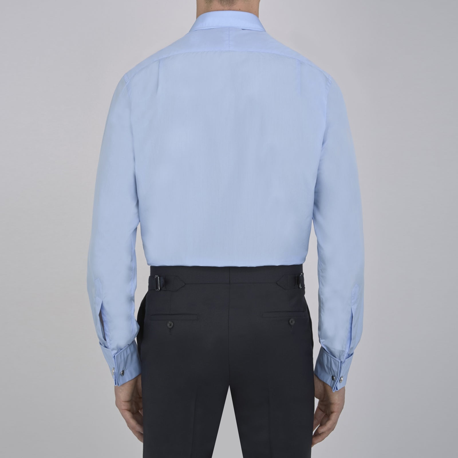 View 3 of product The Turnbull & Asser Two-Fold 200 Blue Cotton Shirt features a T&A collar, double cuffs, white buttons, and a visible label inside the collar, displayed neatly folded on a plain white background for superior breathability.