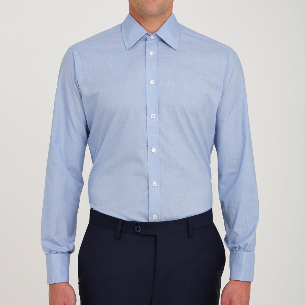The Turnbull & Asser Blue Prince of Wales Check Shirt features a T&A collar and double cuffs, shown against a white background—ideal for timeless, minimalist style.