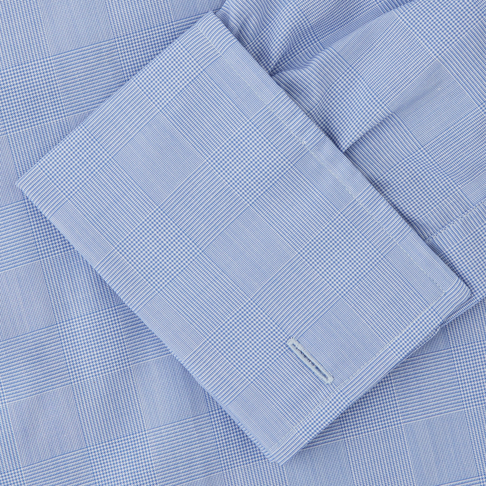 The Turnbull & Asser Blue Prince of Wales Check Shirt features a T&A collar and double cuffs, shown against a white background—ideal for timeless, minimalist style.