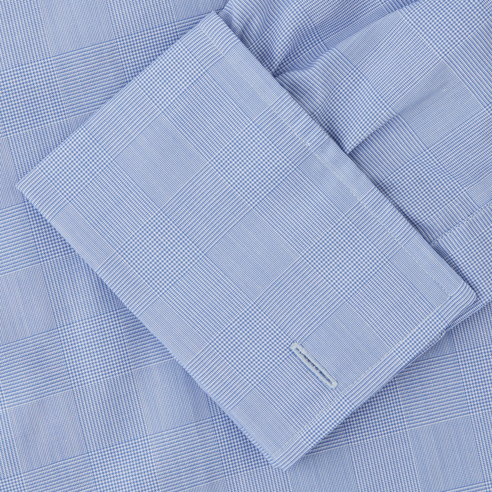 View 6 of product The Turnbull & Asser Blue Prince of Wales Check Shirt features a T&A collar and double cuffs, shown against a white background—ideal for timeless, minimalist style.
