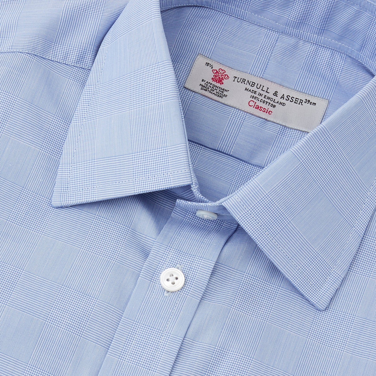 View 5 of product The Turnbull & Asser Blue Prince of Wales Check Shirt features a T&A collar and double cuffs, shown against a white background—ideal for timeless, minimalist style.