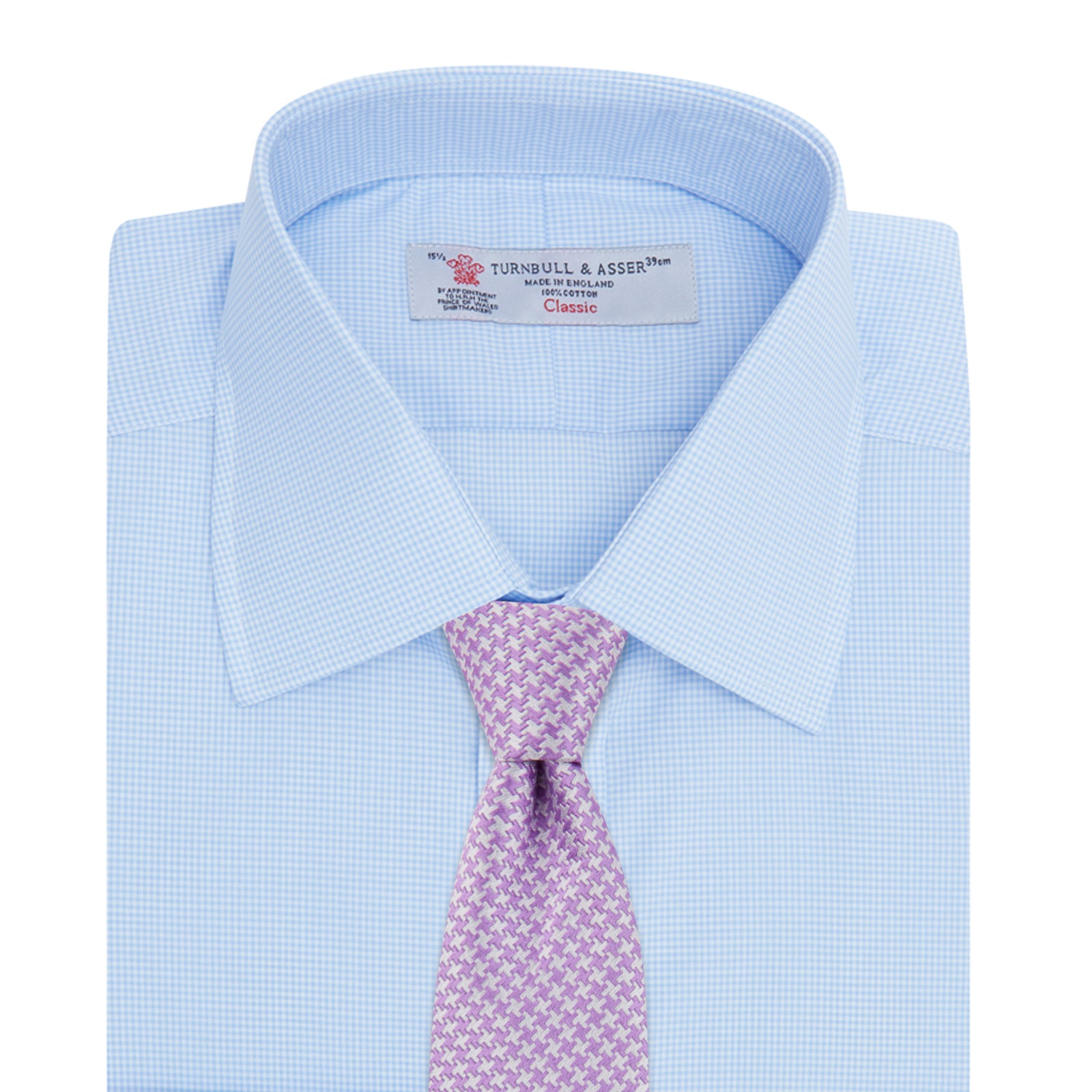 View 4 of product The Sky Blue Micro-Check Cotton Shirt by Turnbull & Asser features a T&A collar and 3-button cuffs, offering a refined take on classic British style. The shirt is neatly folded, showcasing its signature elegance against a white background.