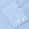 View 6 of product The Sky Blue Micro-Check Cotton Shirt by Turnbull & Asser features a T&A collar and 3-button cuffs, offering a refined take on classic British style. The shirt is neatly folded, showcasing its signature elegance against a white background.