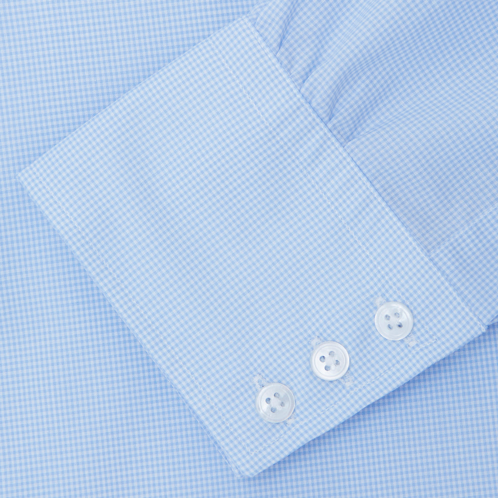The Sky Blue Micro-Check Cotton Shirt by Turnbull & Asser features a T&A collar and 3-button cuffs, offering a refined take on classic British style. The shirt is neatly folded, showcasing its signature elegance against a white background.