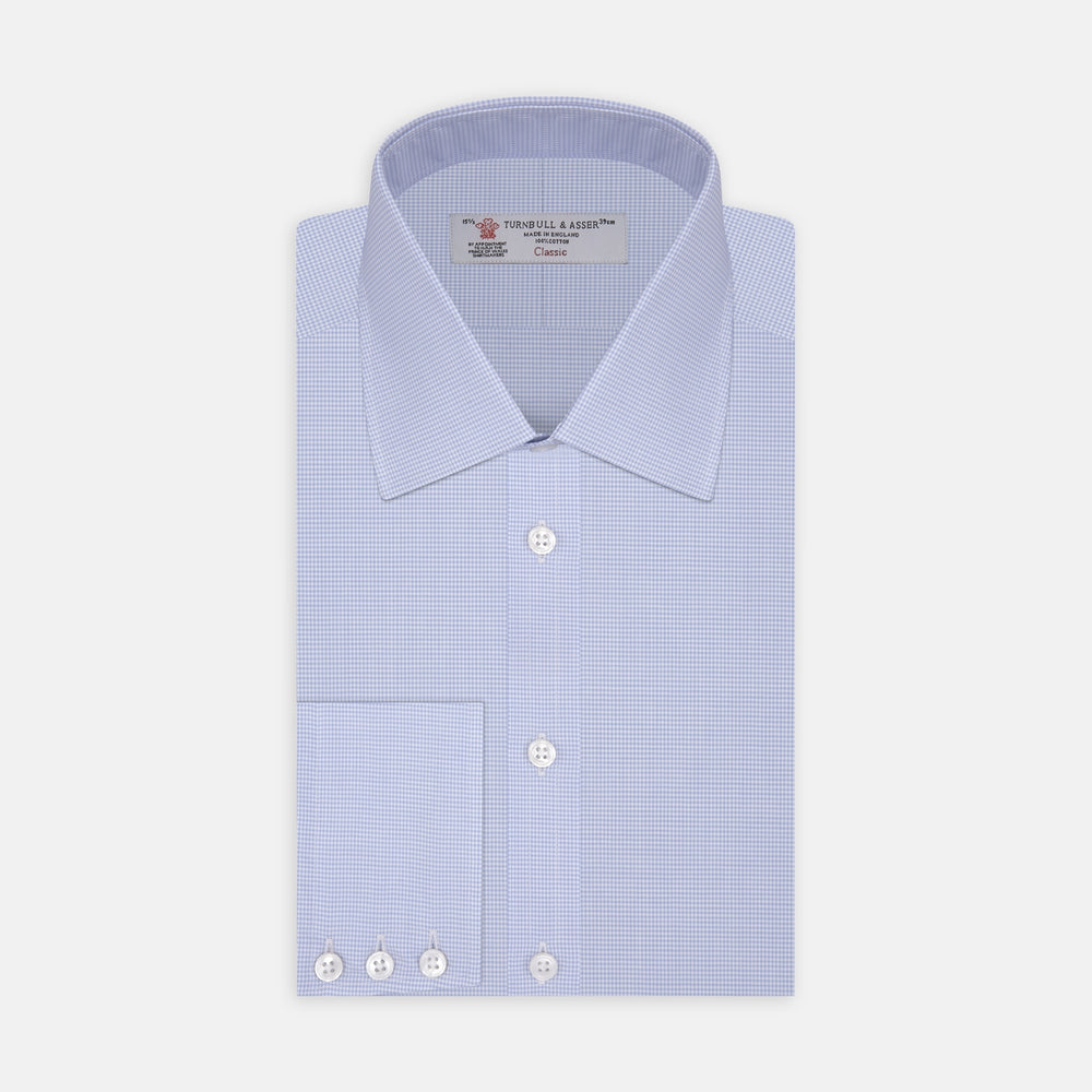 The Sky Blue Micro-Check Cotton Shirt by Turnbull & Asser features a T&A collar and 3-button cuffs, offering a refined take on classic British style. The shirt is neatly folded, showcasing its signature elegance against a white background.