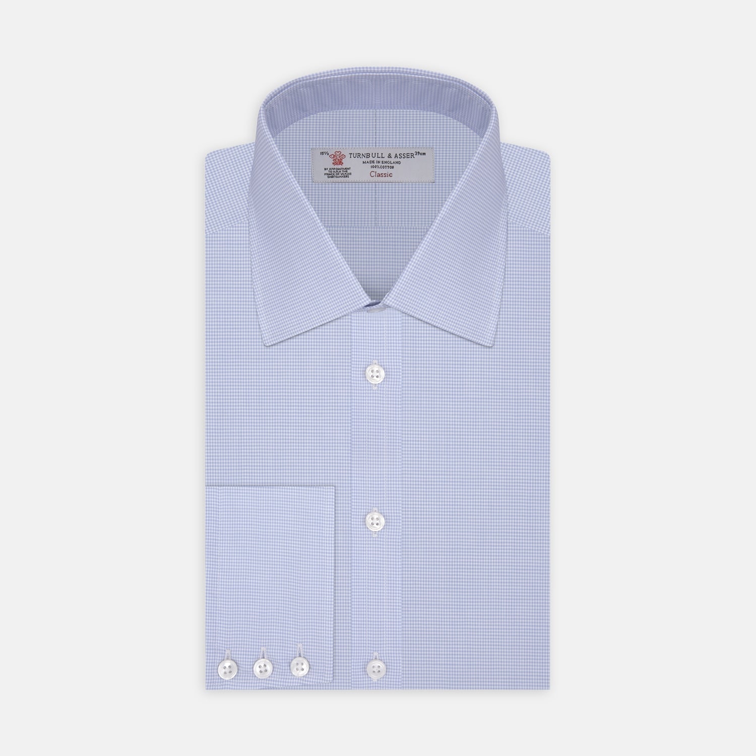 View 1 of product The Sky Blue Micro-Check Cotton Shirt by Turnbull & Asser features a T&A collar and 3-button cuffs, offering a refined take on classic British style. The shirt is neatly folded, showcasing its signature elegance against a white background.
