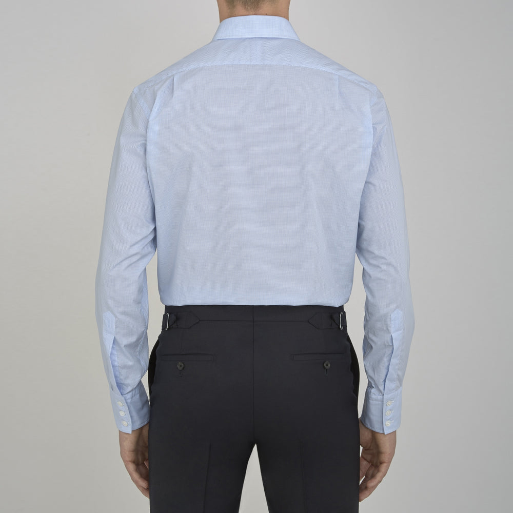 The Sky Blue Micro-Check Cotton Shirt by Turnbull & Asser features a T&A collar and 3-button cuffs, offering a refined take on classic British style. The shirt is neatly folded, showcasing its signature elegance against a white background.