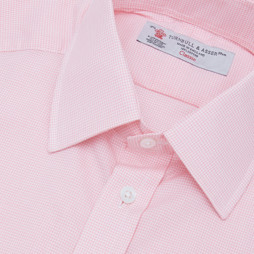 The Turnbull & Asser Pink Micro-Check Cotton Shirt features a T&A collar, 3-button cuffs, and a refined micro-check pattern, shown neatly folded against a white background.