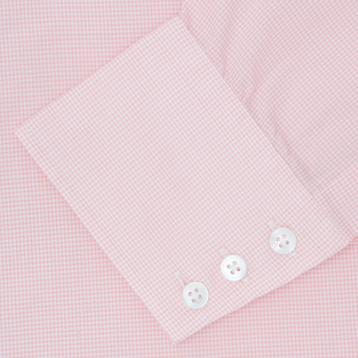 View 6 of product The Turnbull & Asser Pink Micro-Check Cotton Shirt features a T&A collar, 3-button cuffs, and a refined micro-check pattern, shown neatly folded against a white background.