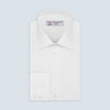 View 1 of product The Turnbull & Asser White Herringbone Superfine Cotton Shirt features a T&A collar and 3-button cuffs, displayed against a light blue background—ideal for minimalist styles or pairing with bold ties.
