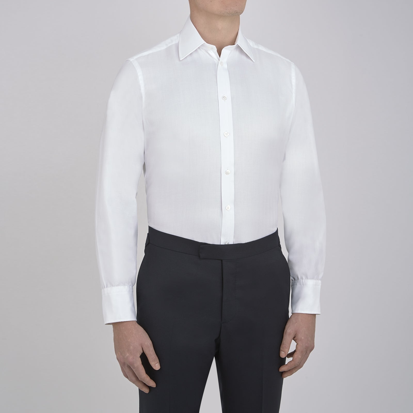 View 2 of product The Turnbull & Asser White Herringbone Superfine Cotton Shirt features a T&A collar and 3-button cuffs, displayed against a light blue background—ideal for minimalist styles or pairing with bold ties.
