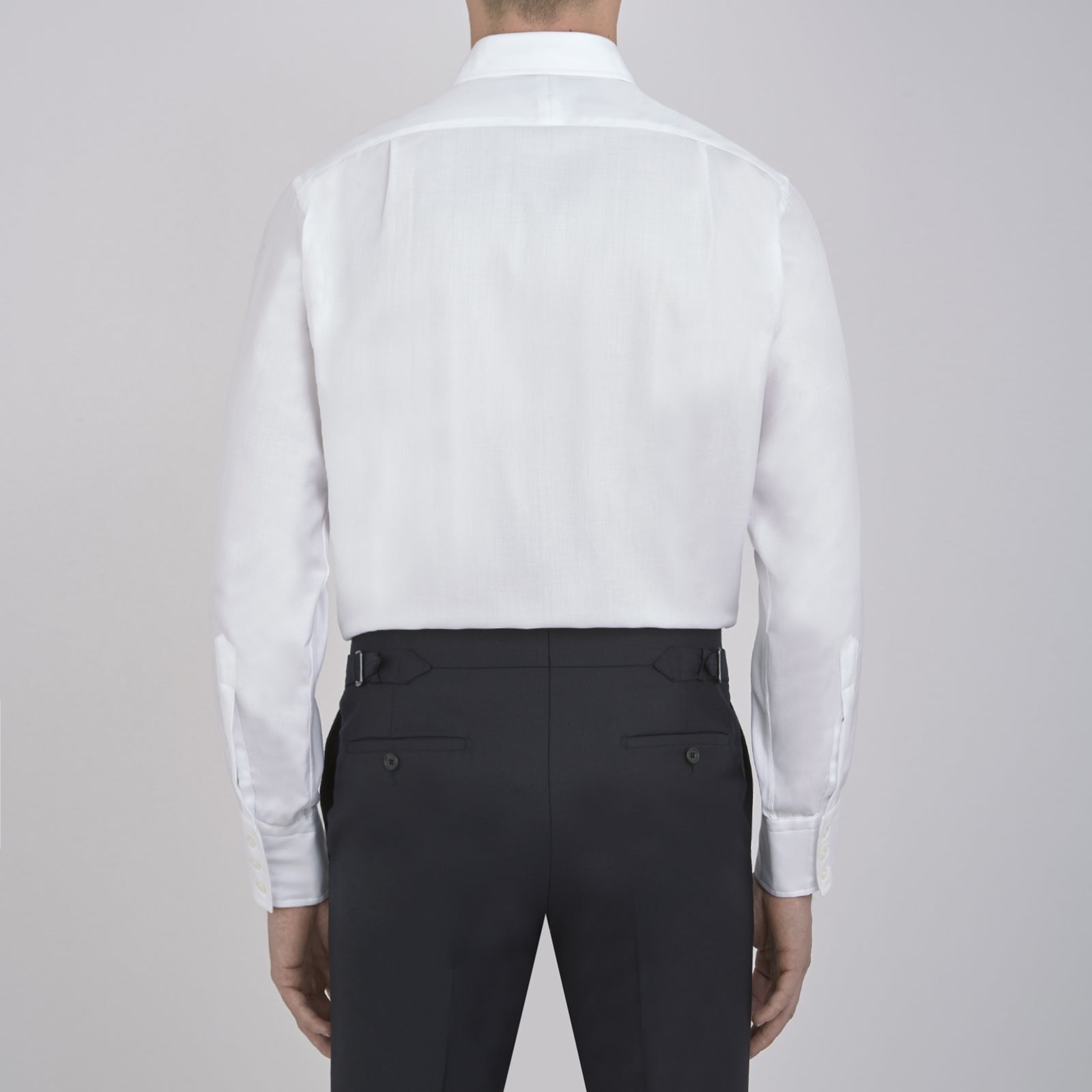 View 3 of product The Turnbull & Asser White Herringbone Superfine Cotton Shirt features a T&A collar and 3-button cuffs, displayed against a light blue background—ideal for minimalist styles or pairing with bold ties.