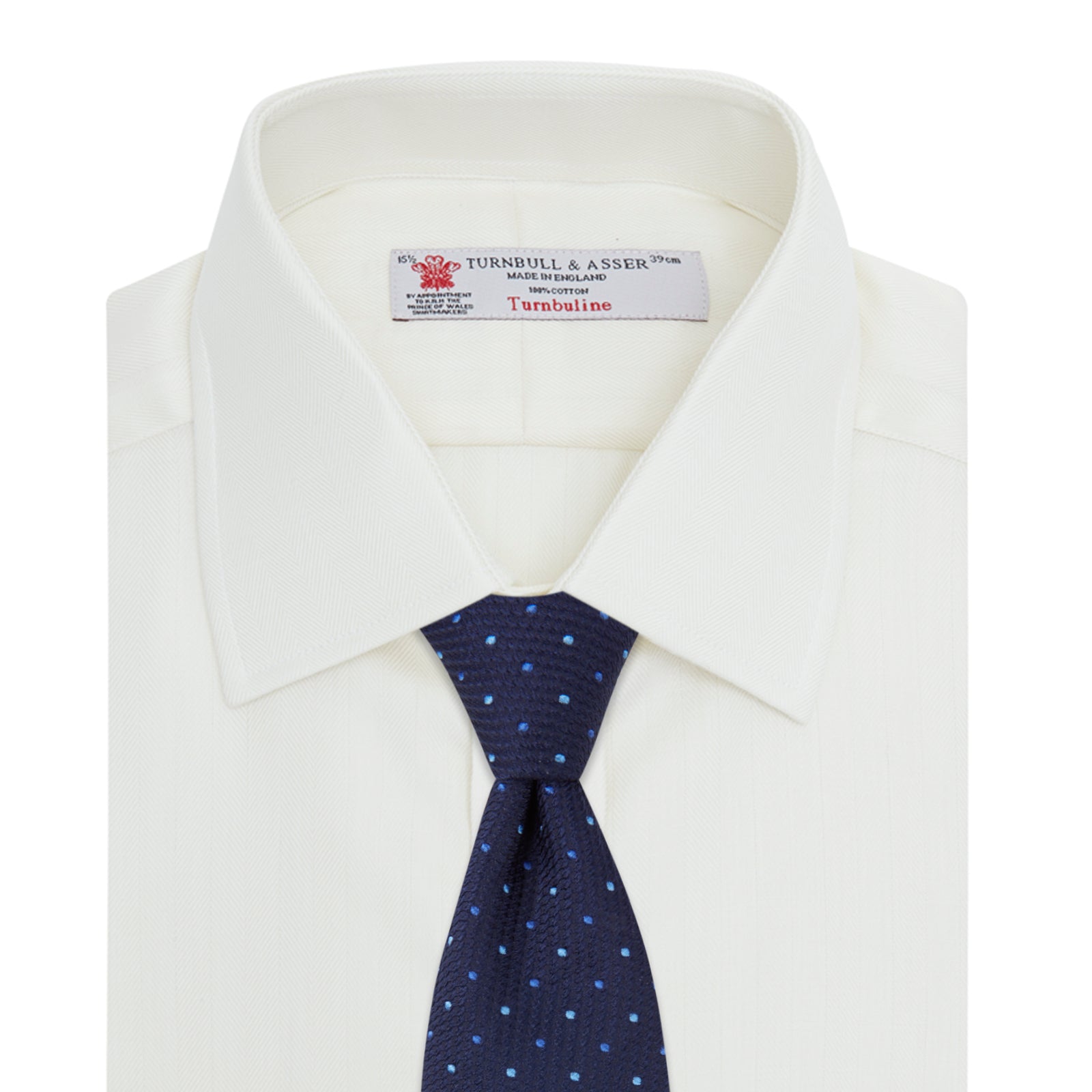 View 4 of product The Turnbull & Asser Cream Herringbone Superfine Cotton Shirt features a T&A collar and 3-button cuffs, ideal for minimalist style or bold ties, shown neatly folded against a plain white background.
