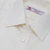 View 5 of product The Turnbull & Asser Cream Herringbone Superfine Cotton Shirt features a T&A collar and 3-button cuffs, ideal for minimalist style or bold ties, shown neatly folded against a plain white background.