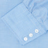 View 6 of product The Blue Herringbone Superfine Cotton Shirt by Turnbull & Asser features a T&A collar and 3-button cuffs, offering a refined minimalist look. Displayed against a plain white background.