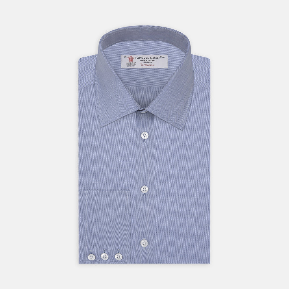 The Blue Herringbone Superfine Cotton Shirt by Turnbull & Asser features a T&A collar and 3-button cuffs, offering a refined minimalist look. Displayed against a plain white background.