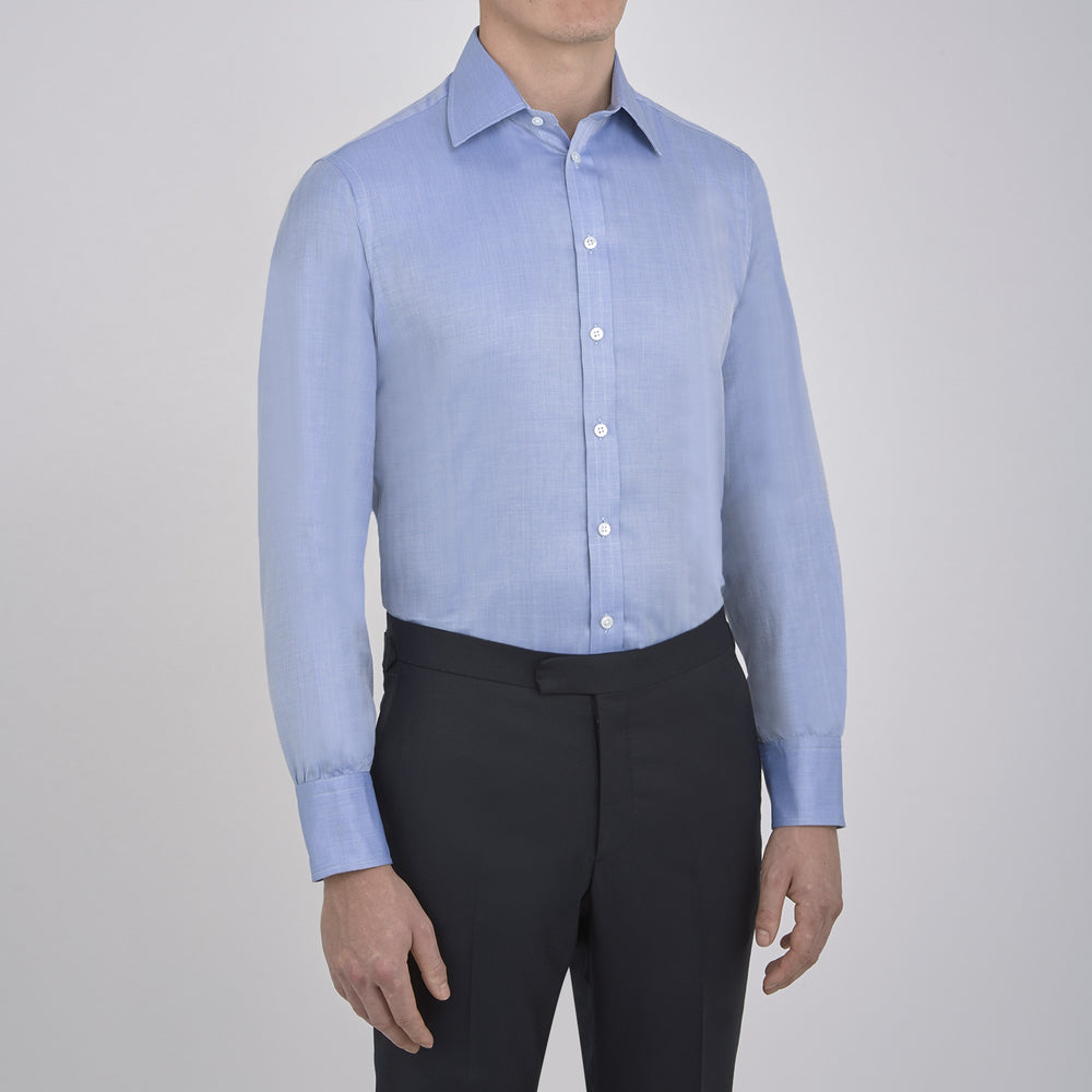 The Blue Herringbone Superfine Cotton Shirt by Turnbull & Asser features a T&A collar and 3-button cuffs, offering a refined minimalist look. Displayed against a plain white background.