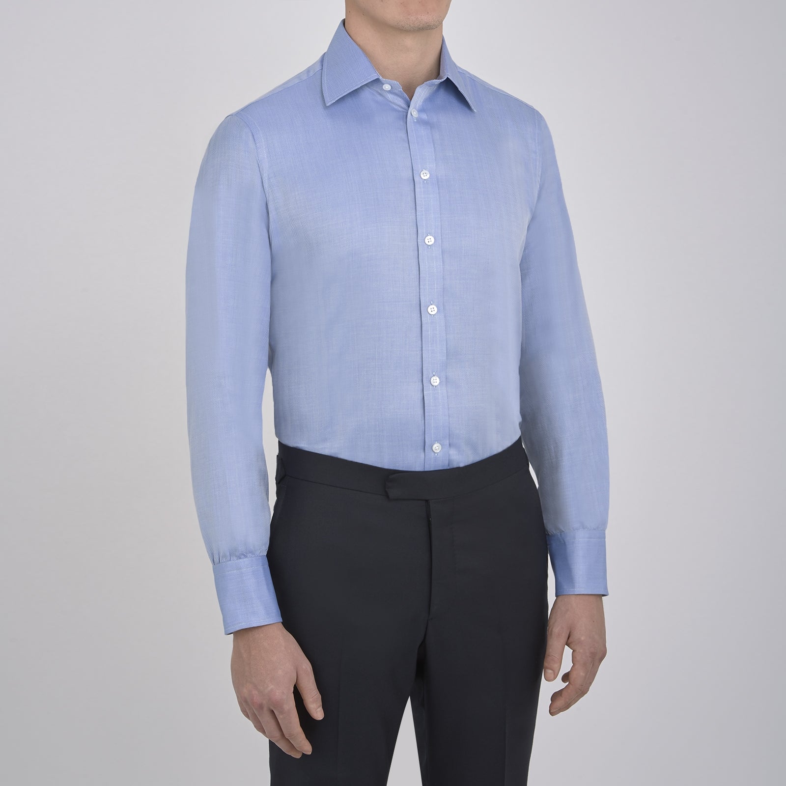 View 2 of product The Blue Herringbone Superfine Cotton Shirt by Turnbull & Asser features a T&A collar and 3-button cuffs, offering a refined minimalist look. Displayed against a plain white background.