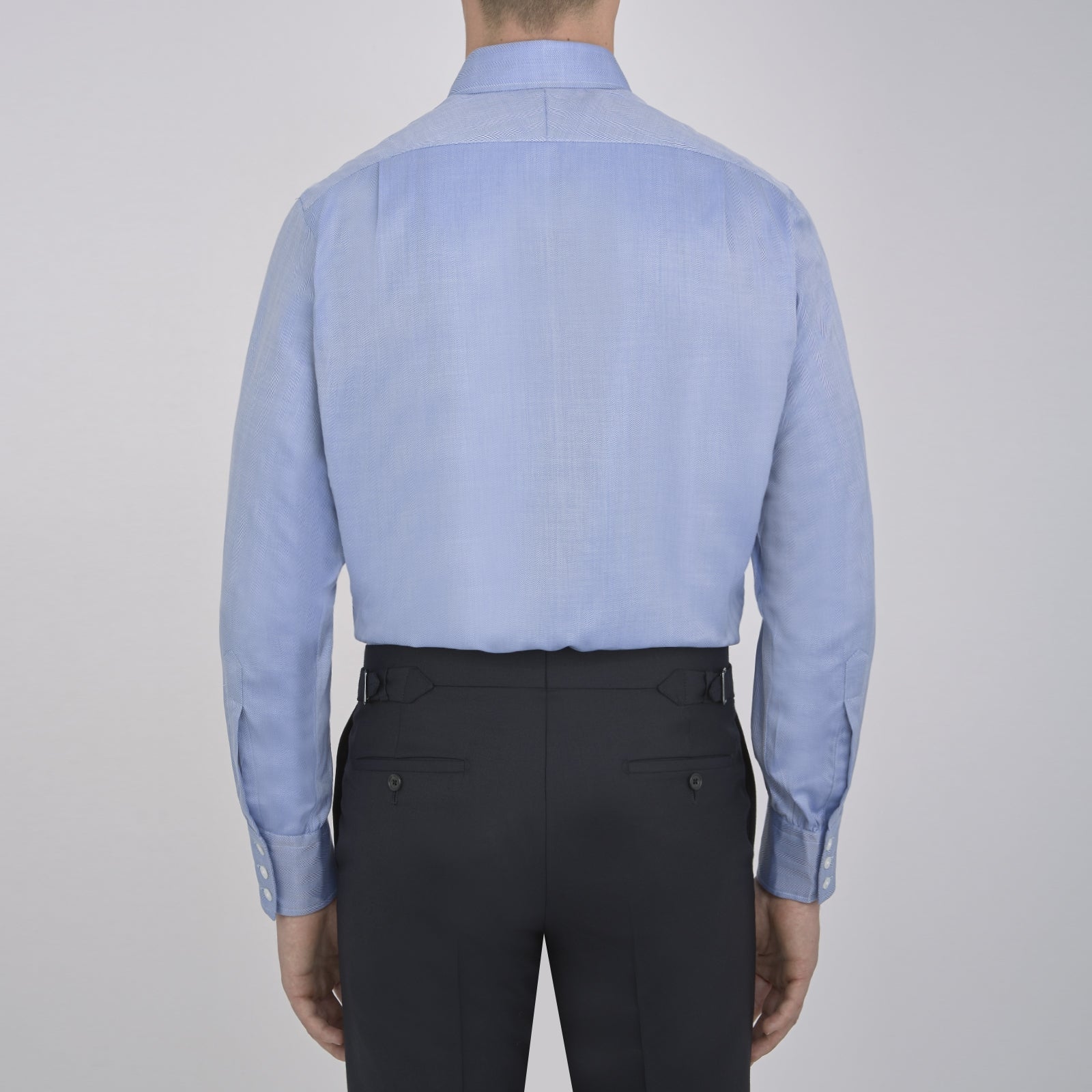 View 3 of product The Blue Herringbone Superfine Cotton Shirt by Turnbull & Asser features a T&A collar and 3-button cuffs, offering a refined minimalist look. Displayed against a plain white background.