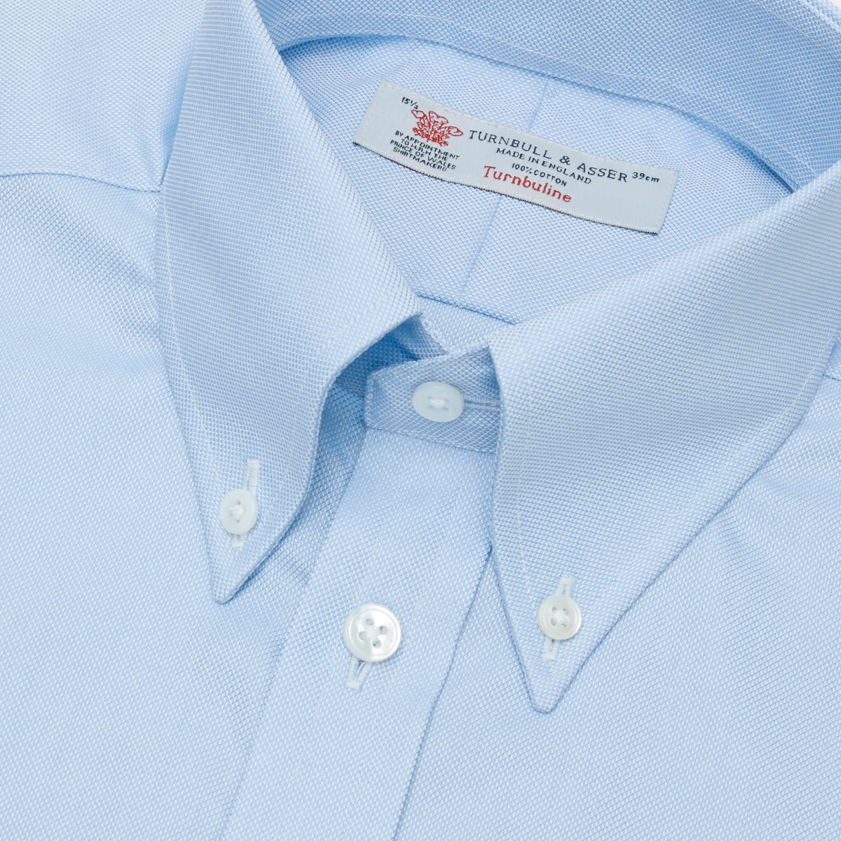 View 5 of product Turnbull & Asser's Light Blue Royal Oxford Cotton Shirt features a button-down collar, 3-button cuffs, and white buttons. Men's shirt comes neatly folded, with a branded neck label displaying garment details—ideal under a navy suit.