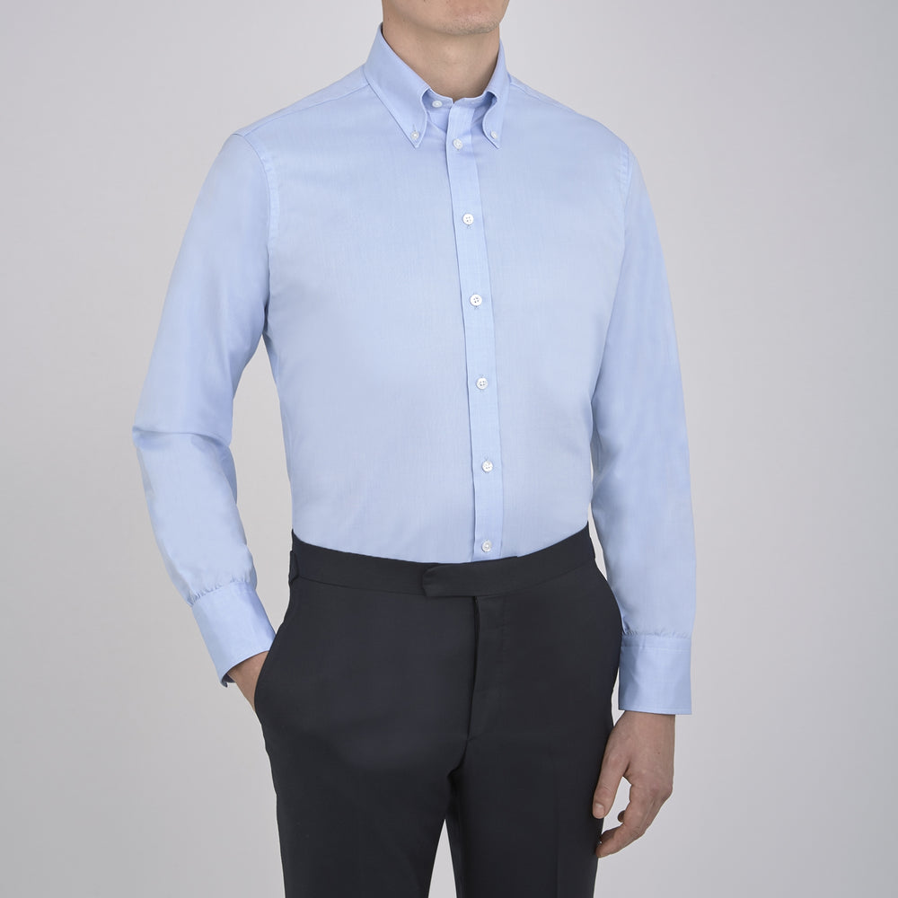 Turnbull & Asser's Light Blue Royal Oxford Cotton Shirt features a button-down collar, 3-button cuffs, and white buttons. Men's shirt comes neatly folded, with a branded neck label displaying garment details—ideal under a navy suit.