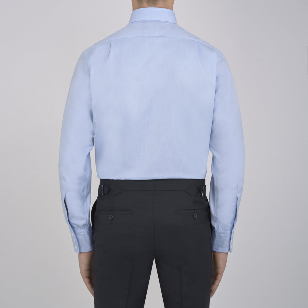 Turnbull & Asser's Light Blue Royal Oxford Cotton Shirt features a button-down collar, 3-button cuffs, and white buttons. Men's shirt comes neatly folded, with a branded neck label displaying garment details—ideal under a navy suit.