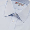 View 5 of product A neatly folded light blue long-sleeve dress shirt with a pointed collar and white buttons, styled with the Turnbull & Asser Monochrome Paisley Mill Silk Pocket Square (limited edition), displayed against a plain white background.