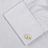 View 6 of product A neatly folded light blue long-sleeve dress shirt with a pointed collar and white buttons, styled with the Turnbull & Asser Monochrome Paisley Mill Silk Pocket Square (limited edition), displayed against a plain white background.