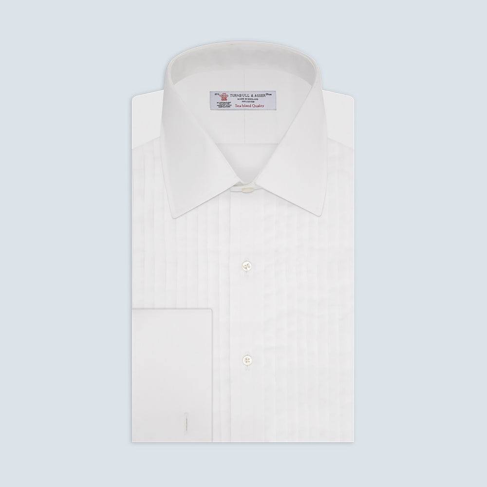 The Turnbull & Asser White Sea Island Quality Cotton Dress Shirt features a T&A collar and double cuffs, elegantly displayed on a light gray background.