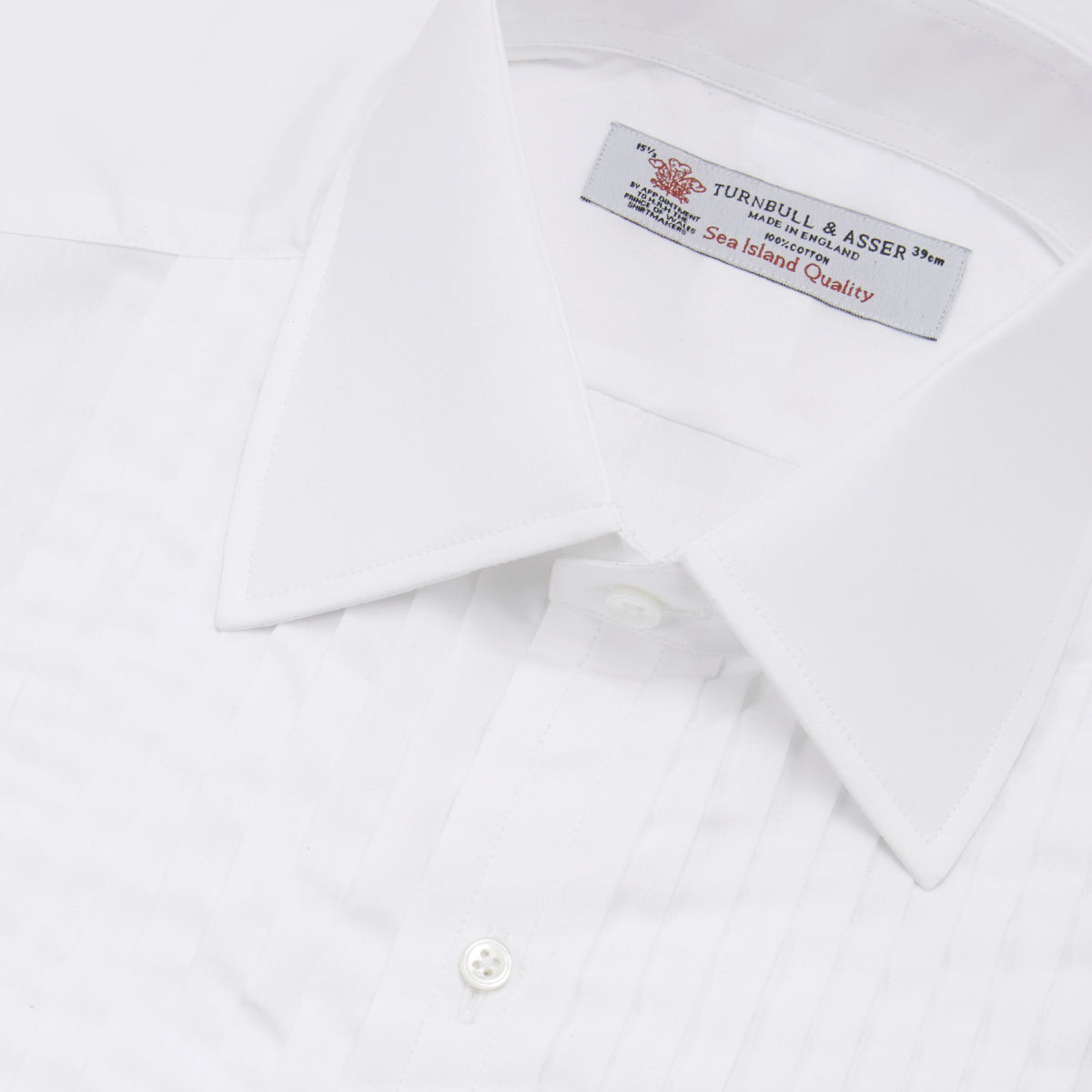 View 5 of product The Turnbull & Asser White Sea Island Quality Cotton Dress Shirt features a T&A collar and double cuffs, elegantly displayed on a light gray background.