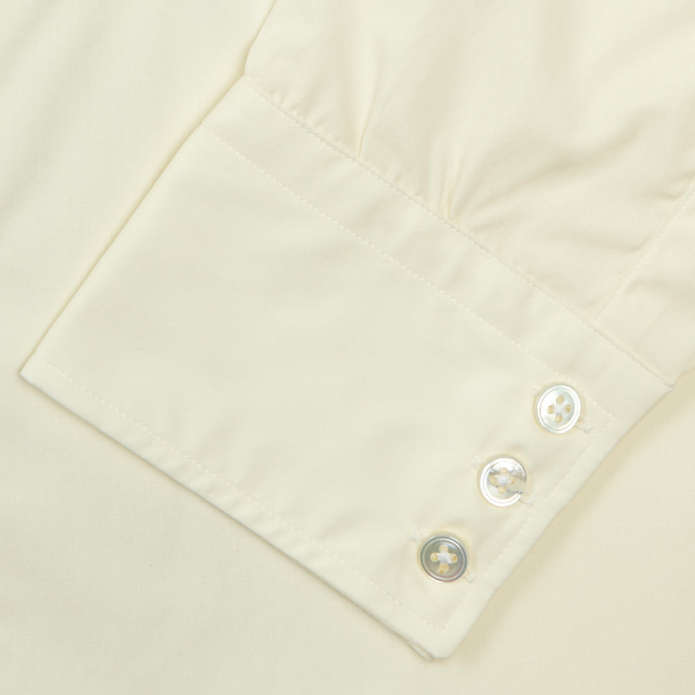 The Cream Sea Island Quality Cotton Shirt by Turnbull & Asser features a T&A collar and 3-button cuffs, crafted from premium cotton and displayed neatly folded against a plain white background.