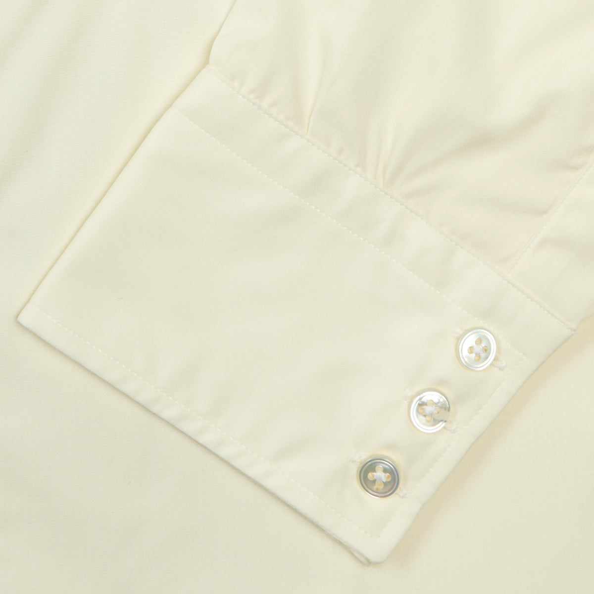 View 6 of product The Cream Sea Island Quality Cotton Shirt by Turnbull & Asser features a T&A collar and 3-button cuffs, crafted from premium cotton and displayed neatly folded against a plain white background.