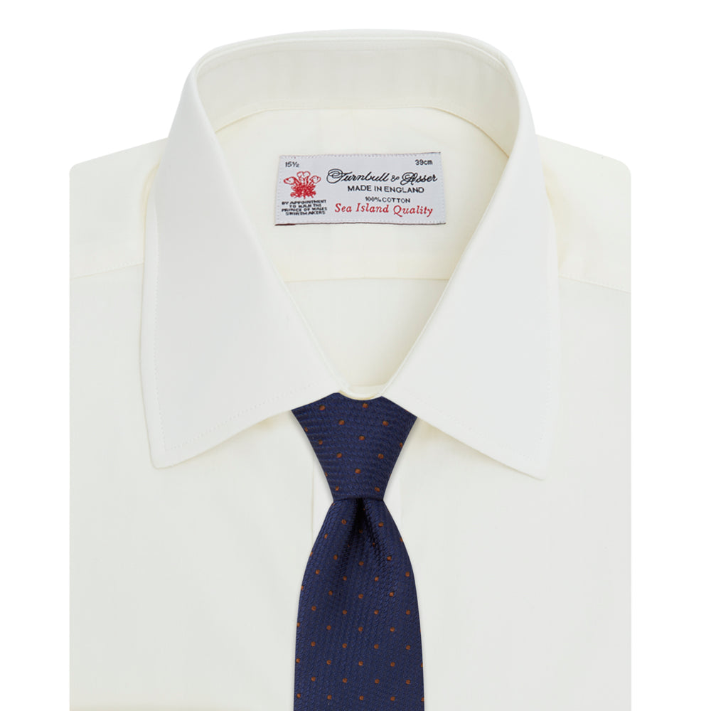 The Turnbull & Asser Cream Sea Island Quality Cotton Shirt features a T&A collar, double cuffs, and a button-down front, elegantly displayed against a white background.