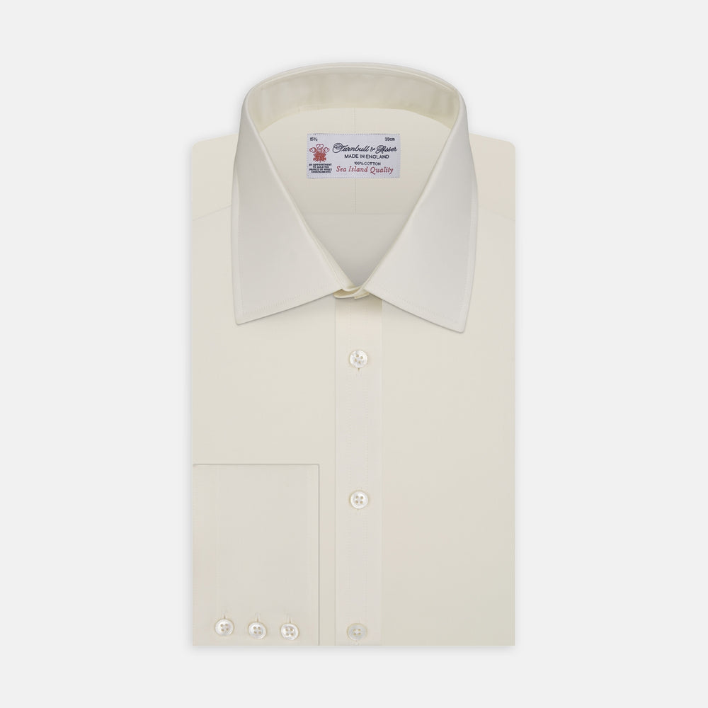 The Cream Sea Island Quality Cotton Shirt by Turnbull & Asser features a T&A collar and 3-button cuffs, crafted from premium cotton and displayed neatly folded against a plain white background.