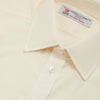 View 5 of product The Turnbull & Asser Cream Sea Island Quality Cotton Shirt features a T&A collar, double cuffs, and a button-down front, elegantly displayed against a white background.