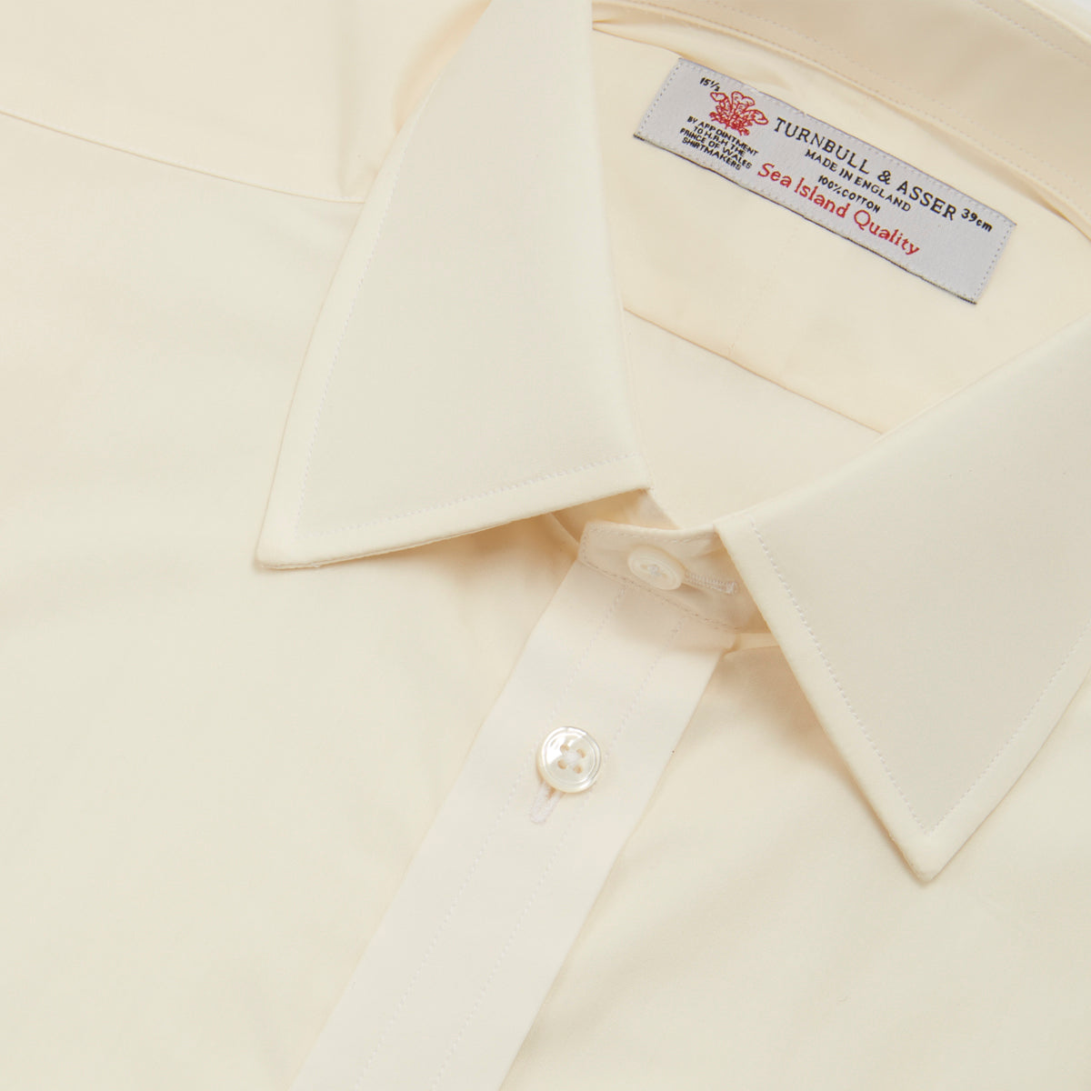 View 5 of product The Turnbull & Asser Cream Sea Island Quality Cotton Shirt features a T&A collar, double cuffs, and a button-down front, elegantly displayed against a white background.