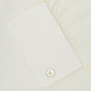 View 6 of product The Turnbull & Asser Cream Sea Island Quality Cotton Shirt features a T&A collar, double cuffs, and a button-down front, elegantly displayed against a white background.