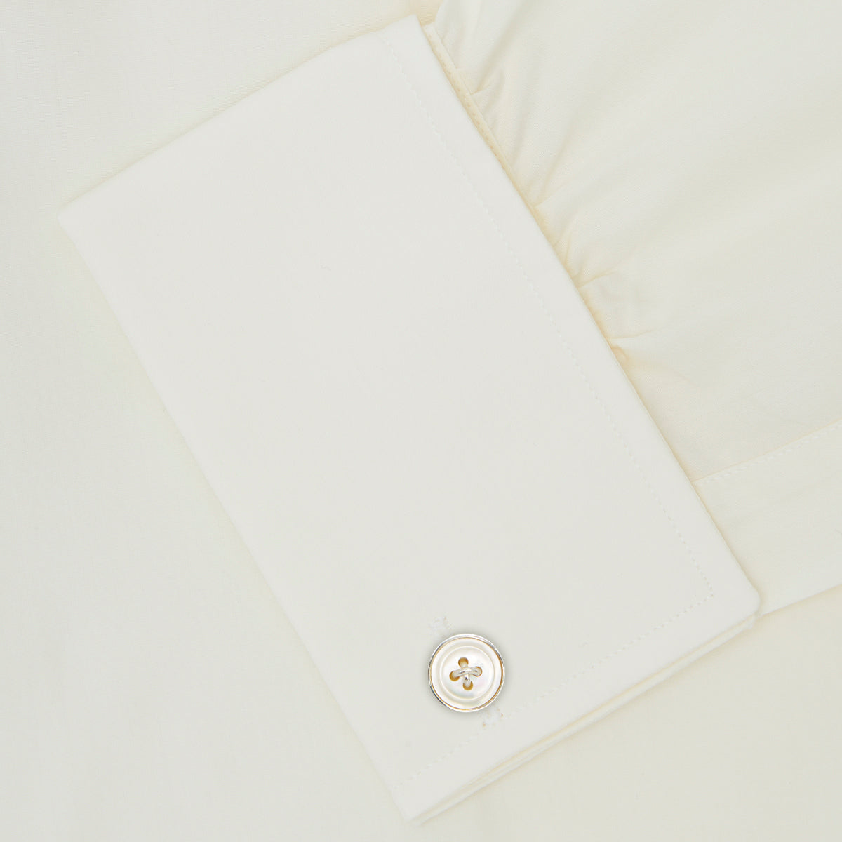 View 6 of product The Turnbull & Asser Cream Sea Island Quality Cotton Shirt features a T&A collar, double cuffs, and a button-down front, elegantly displayed against a white background.