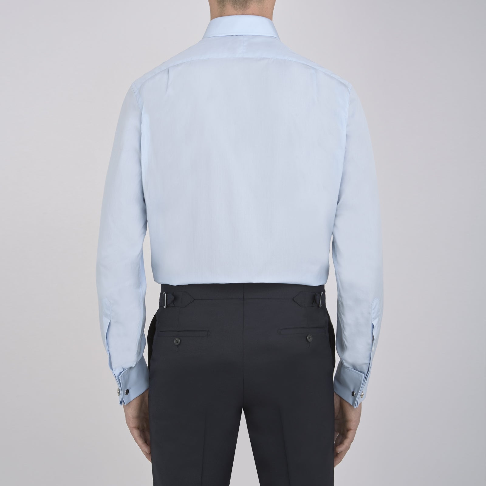 View 3 of product A neatly folded Light Blue Sea Island Quality Cotton Shirt by Turnbull & Asser, featuring a T&A collar and double cuffs, is displayed against a plain white background with the brand label visible inside the collar.