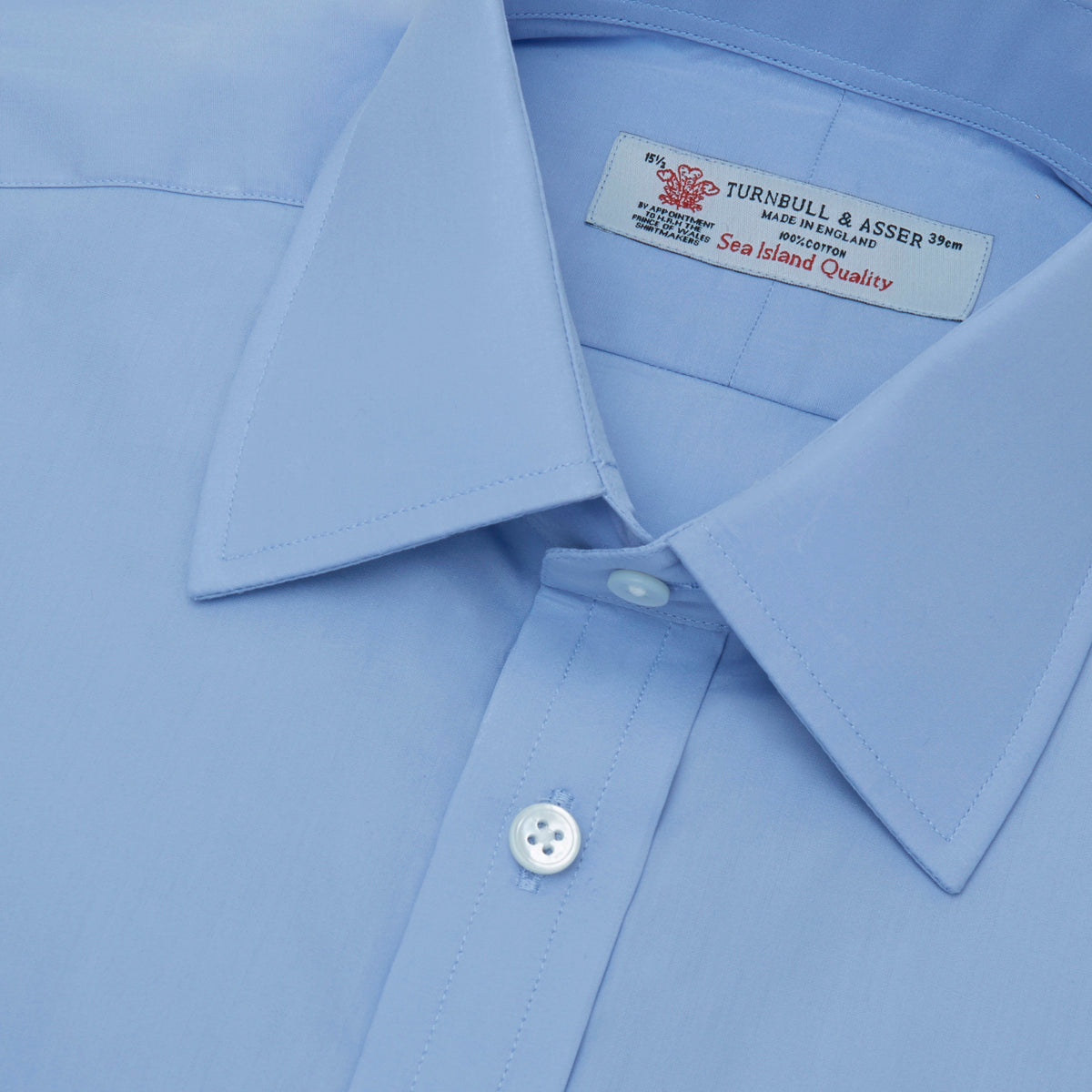 View 5 of product A pair of neatly folded light khaki pure cotton socks by Turnbull & Asser is displayed against a plain white background, their label visible and evoking the understated elegance typical of premium accessories.