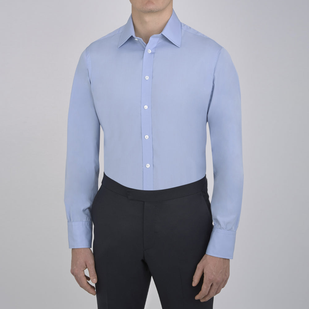 A pair of neatly folded light khaki pure cotton socks by Turnbull & Asser is displayed against a plain white background, their label visible and evoking the understated elegance typical of premium accessories.