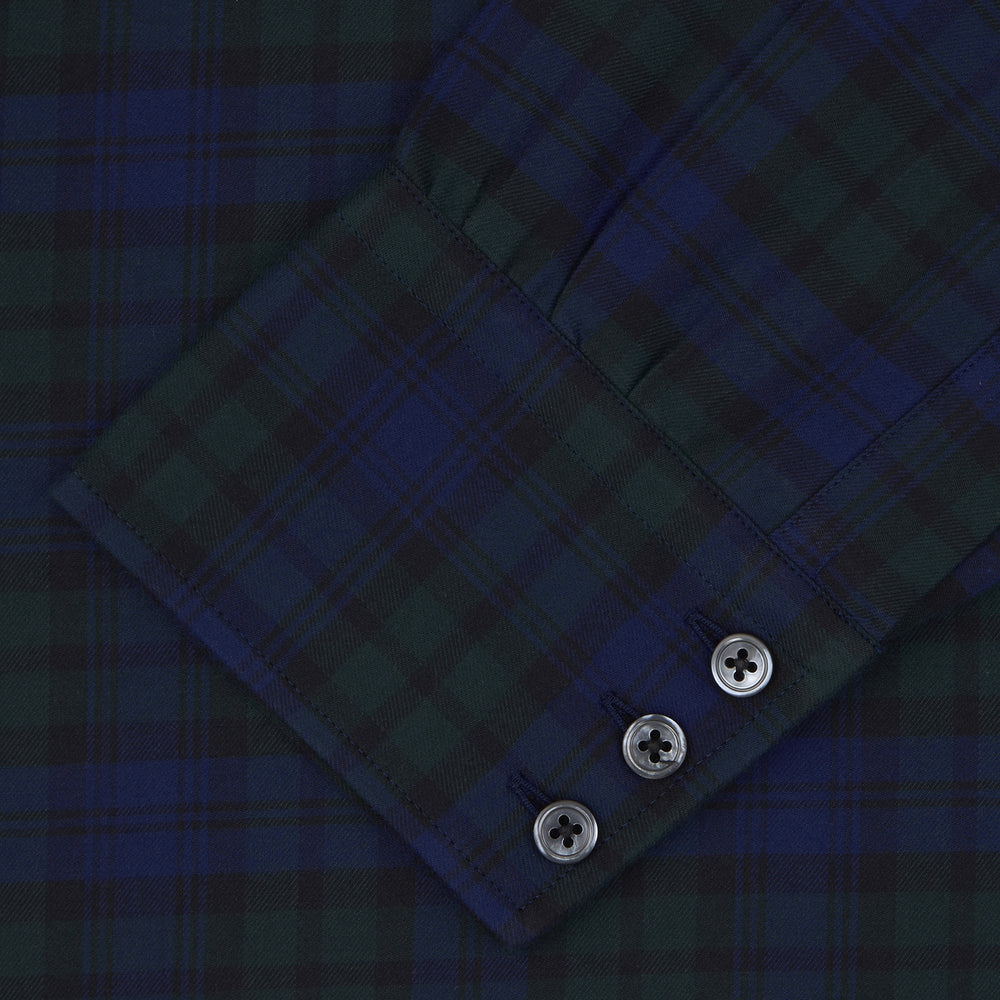 The Turnbull & Asser Blackwatch Brushed Cotton Shirt features a T&A collar, button cuffs, and a stylish dark blue and green plaid—perfect for any seasonal collection. Displayed here neatly folded on a plain white background.