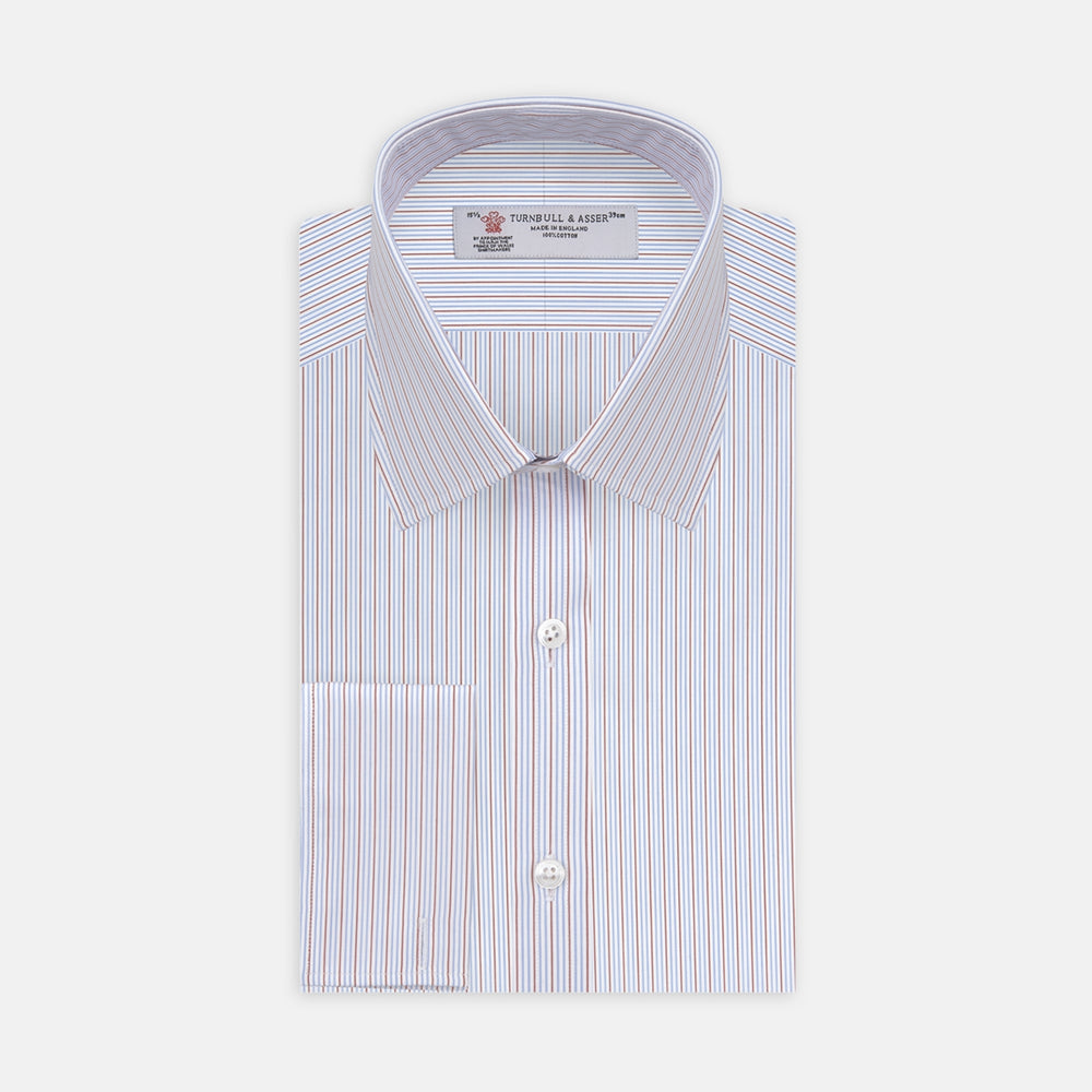The Turnbull & Asser Red and Navy Supraluxe Stripe Shirt features a T&A collar, double cuffs, and thin vertical blue and red stripes on white premium cotton. Displayed folded against a plain white background.