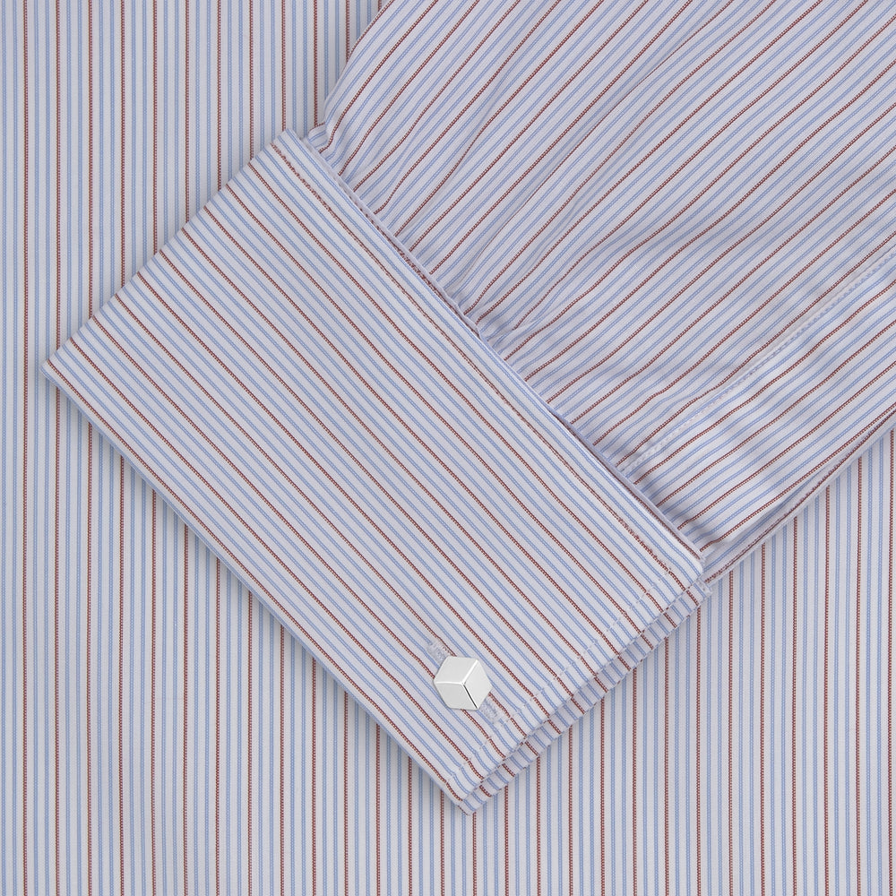 The Turnbull & Asser Red and Navy Supraluxe Stripe Shirt features a T&A collar, double cuffs, and thin vertical blue and red stripes on white premium cotton. Displayed folded against a plain white background.