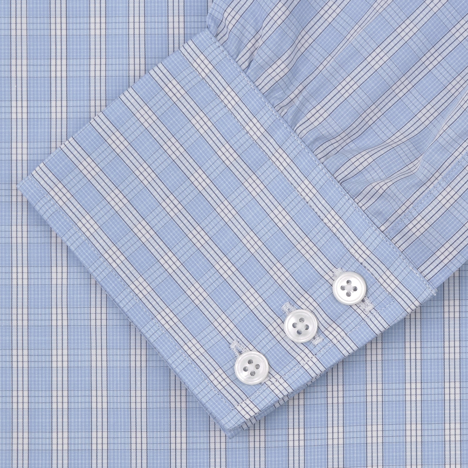 View 2 of product The Turnbull & Asser Blue and White Bold Check Shirt features a T&A collar, 3-button cuffs, and a classic plaid in blue and white, neatly folded with white buttons, displayed on a plain white background.