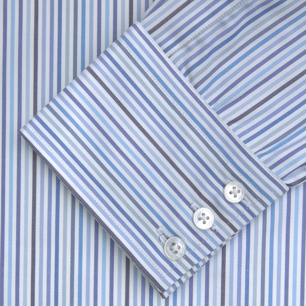 The Turnbull & Asser Blue and White Graph Stripe Shirt features a T&A collar, 3-button cuffs, and crisp vertical stripes, exemplifying refined bespoke tailoring. Displayed neatly folded on a plain light background.