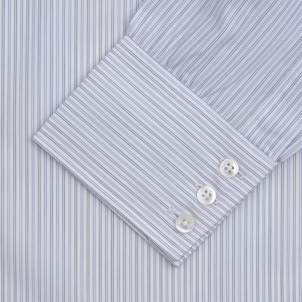 The Turnbull & Asser Light Blue Double Stripe Sea Island Quality Cotton Shirt features a T&A collar, 3-button cuffs, and white buttons, neatly folded and displayed against a plain light background.