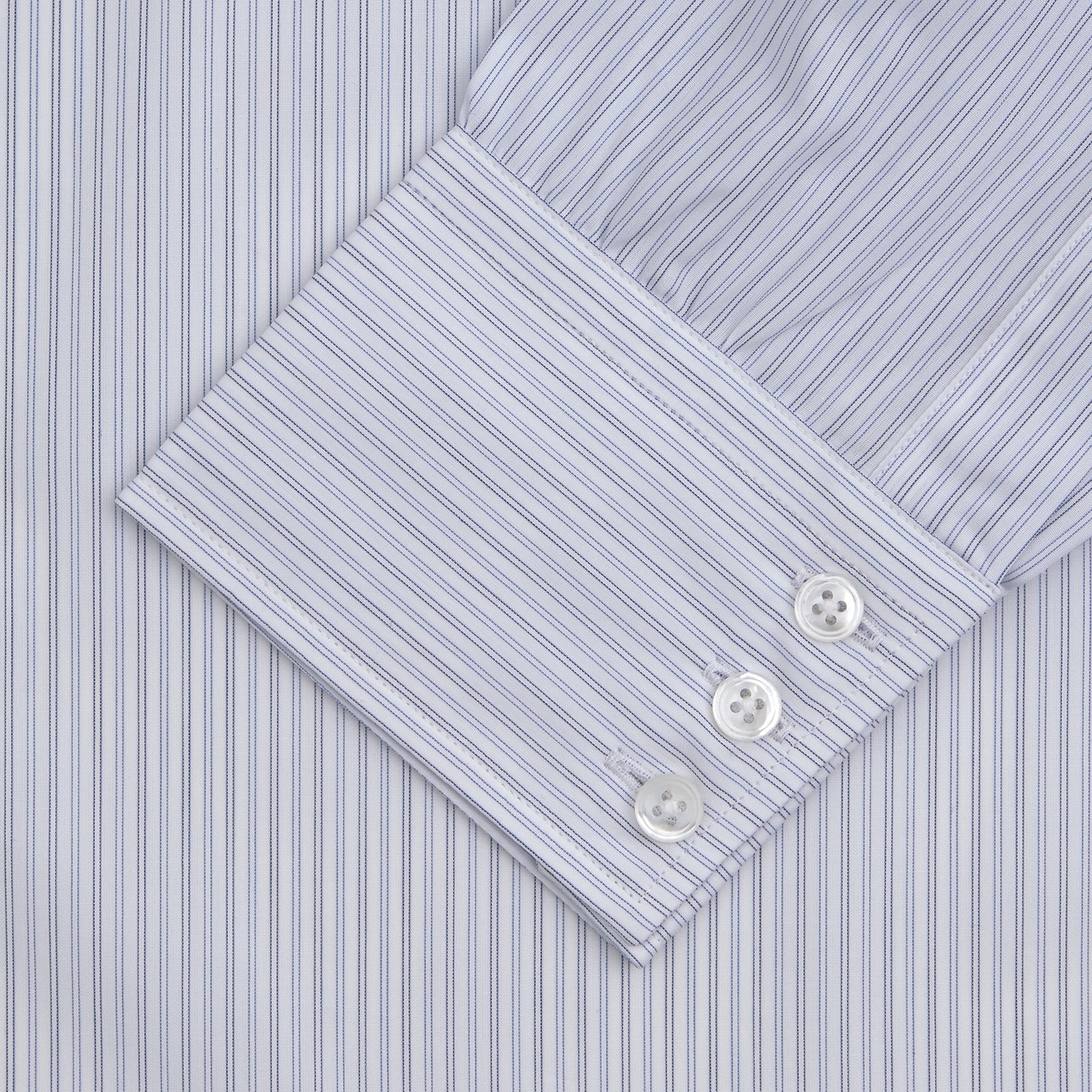 View 2 of product The Turnbull & Asser Light Blue Double Stripe Sea Island Quality Cotton Shirt features a T&A collar, 3-button cuffs, and white buttons, neatly folded and displayed against a plain light background.