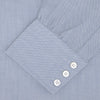 View 4 of product The Turnbull & Asser Blue Cashmere Blend Shirt features a T&A collar and 3-button cuffs, elegantly folded and showcased against a plain white background.